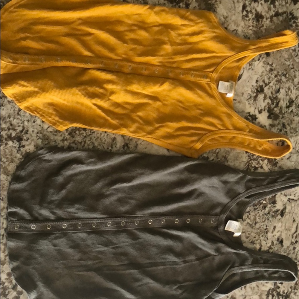 Two different color muscle shirts